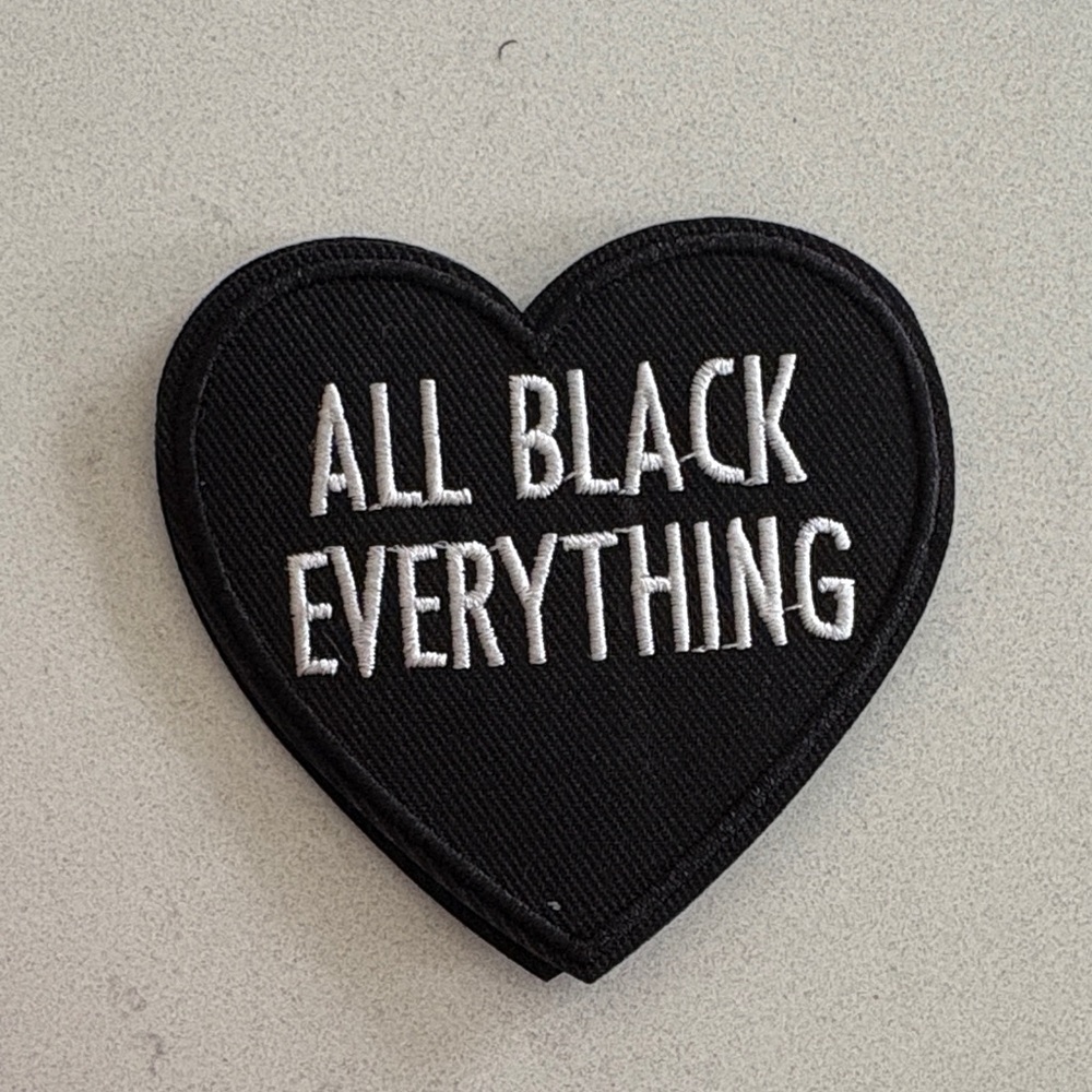 Heart-Shaped Black Patch with White Text